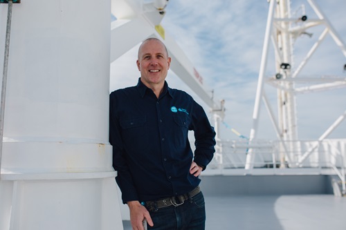 A person standing on the deck of a ship.